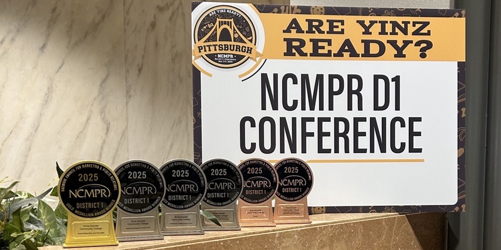 A collection of awards in front of a sign for the NCMPR conference.