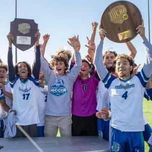 Soccer players holding trophies.