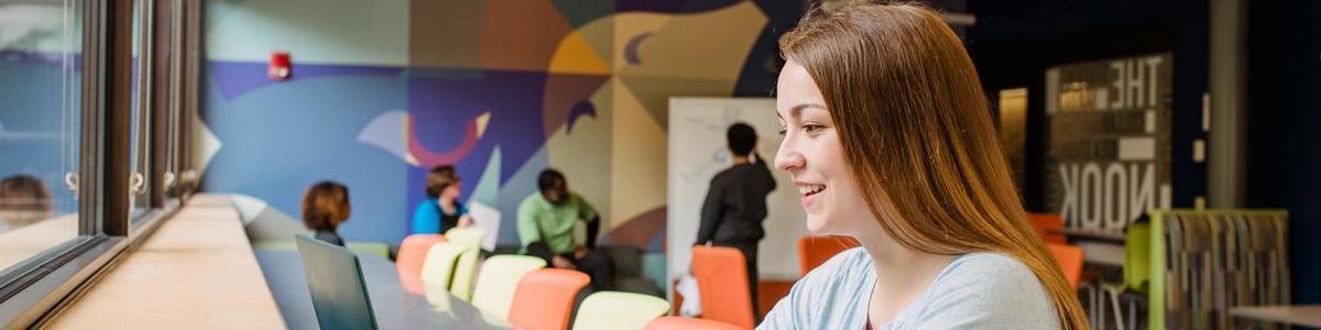 Student using computer on AACC campus.