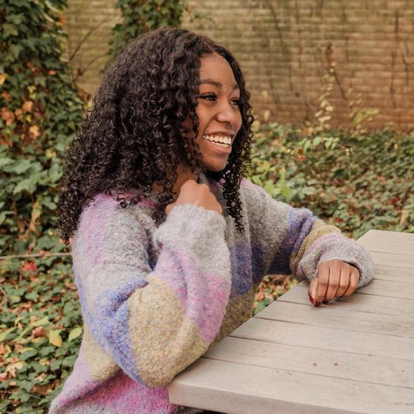 Students at picnic table laughing.