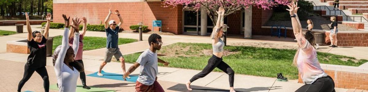 AACC students participating in yoga outside.