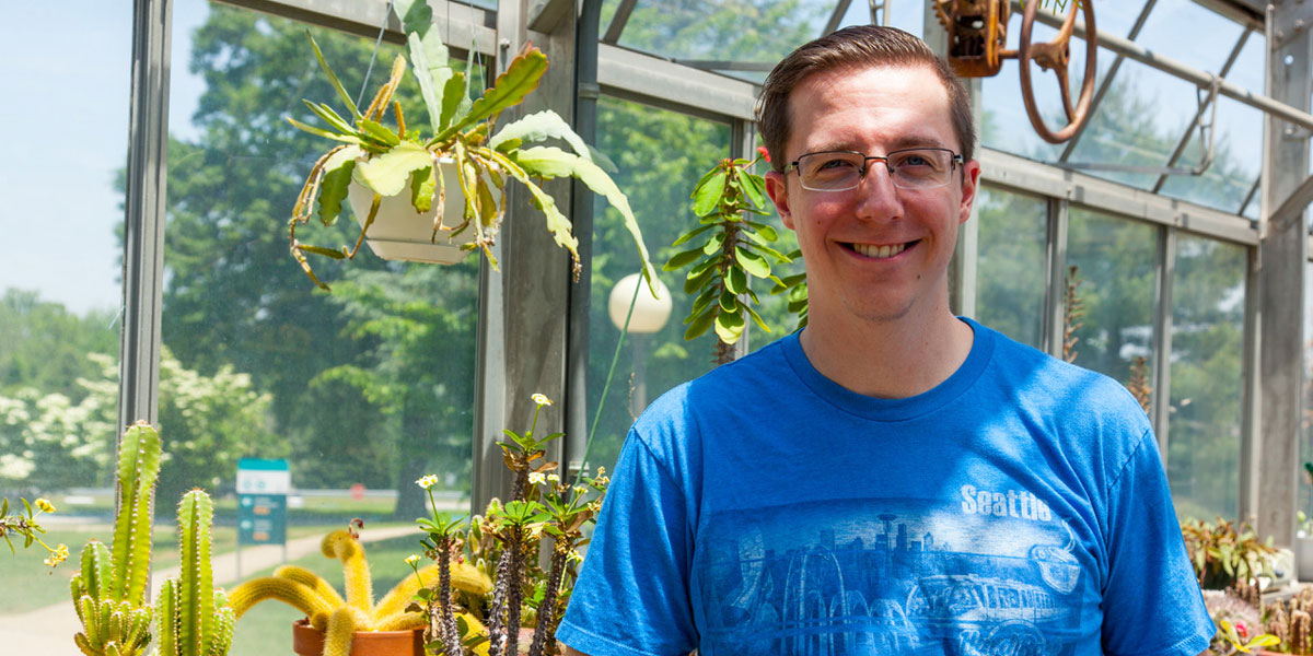 Chris Swift standing in front of plants.