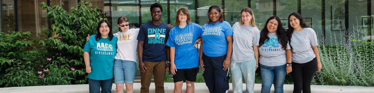 A group of students standing in a line wearing AACC T-shirts.