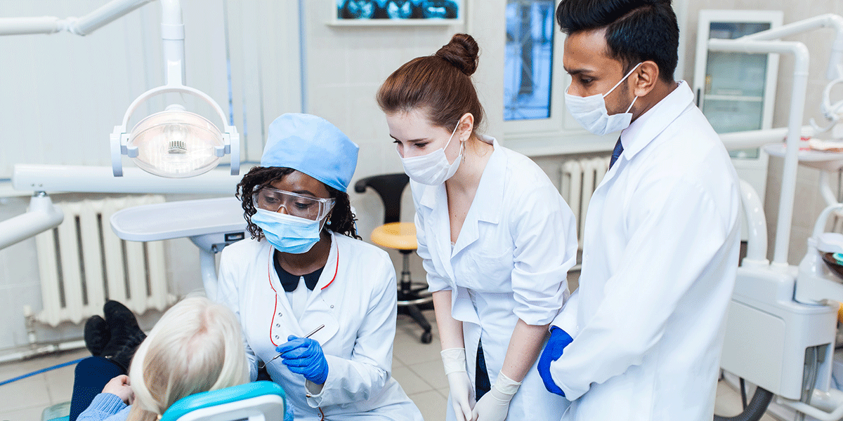 Three people working in dentist's office